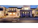 Modern home with a three-car garage, manicured landscaping, and a stylish front entrance at 472 Windstone Crest Ave, Las Vegas, NV 89138