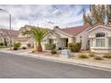 Charming single story home with a two car garage, red tile roof, and desert landscaping in the front yard at 50 Mesquite Village Cir, Henderson, NV 89012