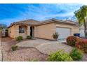 Inviting one-story residence featuring a low maintenance front yard and an attached two-car garage at 5033 Wild Buffalo Ave, Las Vegas, NV 89131