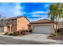 Attractive home with a two-car garage, manicured front yard and desert landscaping in a sunny neighborhood at 5033 Wild Buffalo Ave, Las Vegas, NV 89131