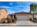 Charming single-story home features a well-maintained front yard, two car garage and neutral color palette at 5033 Wild Buffalo Ave, Las Vegas, NV 89131