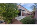 Enjoy the backyard with a covered patio, manicured garden, decorative rock and lush greenery, ideal for outdoor living at 6339 Sharp Rock Ct, Las Vegas, NV 89139