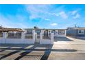 Inviting single-story home with a secure gated yard and fresh exterior paint at 6425 Evergreen Ave, Las Vegas, NV 89107