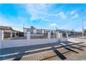 Single-story home showcasing a secure, white-walled gated front yard in a residential area at 6425 Evergreen Ave, Las Vegas, NV 89107