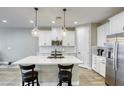 Bright modern kitchen features a large center island with bar stool seating at 712 Monroe Hill Pl, Henderson, NV 89011