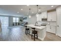 Open floor plan with a modern kitchen and living room with guitars decorating the walls at 712 Monroe Hill Pl, Henderson, NV 89011