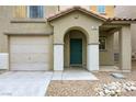 Welcoming front entry with an arched porch, desert landscaping, and attached garage at 7222 Liberty Pride St, Las Vegas, NV 89148