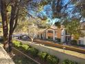 Apartment exterior, landscaped with lawn and shrubs, featuring neutral tones and natural light at 8455 W Sahara Ave # 258, Las Vegas, NV 89117