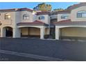 Exterior of condo building with covered parking, showcasing the architectural style and convenient parking at 8455 W Sahara Ave # 258, Las Vegas, NV 89117