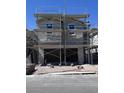 Two-story home under construction with scaffolding and a two-car garage, awaiting its final touches at 9070 Rivington Ave, Las Vegas, NV 89148