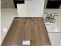 Sample layout of carpet, flooring, counter top, and fixtures in whites and browns for a modern interior design at 9070 Rivington Ave, Las Vegas, NV 89148