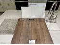 Sample layout of carpet, flooring, counter top, and fixtures in whites and browns for a modern interior design at 9070 Rivington Ave, Las Vegas, NV 89148