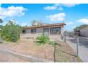 Charming single-story home featuring desert landscaping, fenced yard and neutral color palette at 916 Putnam Ave, North Las Vegas, NV 89030