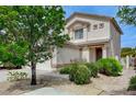 Exterior view of home with neutral stucco, brown trim and desert landscaping at 9264 Ansley Ct, Las Vegas, NV 89148