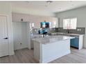 Modern kitchen with white cabinets, an island, and stainless-steel appliances at 970 Mount Charleston Dr, Pahrump, NV 89048