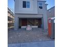 New construction showing the two-story facade and open garage with building supplies at 9989 River Corral St, Las Vegas, NV 89166