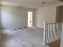 Second floor loft area with carpet flooring, white walls, and natural light at 9989 River Corral St, Las Vegas, NV 89166