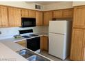 A functional kitchen features bright cabinetry and essential appliances for easy meal preparation at , Las Vegas, NV 89122