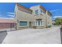 Large backyard featuring a concrete patio, secure fencing, and comfortable seating at 2641 Vendange Pl, Henderson, NV 89044