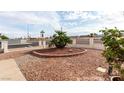 Manicured front yard with decorative gravel, mature plantings, and brick border at 436 Pumpkin Way, Henderson, NV 89015