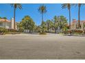Community entrance with lush greenery and 'Villas' signage for a welcoming feel at 5412 Harmony Green Dr # 101, Las Vegas, NV 89149