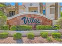 'Villas on the Green' signage amidst manicured landscaping, enhancing community appeal at 5412 Harmony Green Dr # 101, Las Vegas, NV 89149