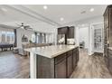 An open floorplan view of a kitchen island, living room, and access to the pantry at 8245 Broad Branch Way, Las Vegas, NV 89113