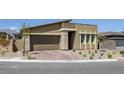 Attractive single-story house with a two-car garage and xeriscaped front yard for easy upkeep at 12438 Heritage Bend Dr, Las Vegas, NV 89138