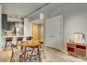 Open floor plan showcasing the kitchen with breakfast bar and a dining area featuring modern decor at 353 E Bonneville Ave # 754, Las Vegas, NV 89101