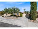 Charming single-story home with well-maintained landscaping and a paved driveway at 496 Grassrange Ln, Henderson, NV 89052
