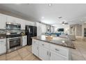 Modern kitchen boasts granite countertops, stainless steel appliances, and ample cabinet space at 496 Grassrange Ln, Henderson, NV 89052