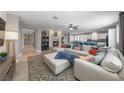 Open concept living room featuring a large sectional sofa, fireplace, and tile flooring at 496 Grassrange Ln, Henderson, NV 89052