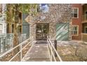 Inviting building entrance with stone facade and well-maintained landscaping at 50 E Serene Ave # 107, Las Vegas, NV 89123