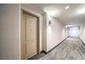 Well-lit hallway with patterned carpet and neutral-toned walls at 50 E Serene Ave # 107, Las Vegas, NV 89123