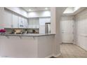 Open kitchen boasts granite counters, white cabinets and stainless steel appliances; perfect for entertaining at 50 E Serene Ave # 107, Las Vegas, NV 89123