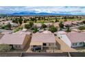 Expansive aerial shot of a residential community with mountain views and a golf course at 7460 Chaffinch St, North Las Vegas, NV 89084