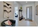 Contemporary entryway boasting a bench, coat rack, and stylish decor at 9974 Petroglyph Canyon Ave, Las Vegas, NV 89166