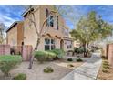 Beautifully landscaped front yard with mature trees and sidewalk leading to this two-story home at 11036 Mount Hunter St, Las Vegas, NV 89179
