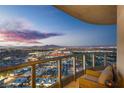 Balcony seating offers city views in the evening at 322 Karen Ave # 4207, Las Vegas, NV 89109