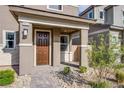 Welcoming townhome exterior with a covered entrance, stone accents, and well-maintained landscaping at 4533 Queens Hill St, North Las Vegas, NV 89031