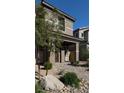 Inviting townhome exterior with a paved walkway, covered entrance, and desert-friendly landscaping at 4533 Queens Hill St, North Las Vegas, NV 89031