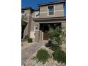 Inviting front entrance with a manicured garden, stone accents, and a covered porch, great curb appeal at 4533 Queens Hill St, North Las Vegas, NV 89031
