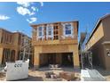 Exterior view of home in the framing stage of construction with open garage at 10026 Indy Rey Ct, Las Vegas, NV 89148