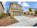 Beautiful home showcasing a well-maintained lawn, neutral color palette, and attached garage at 10393 Trailing Dalea Ave, Las Vegas, NV 89135