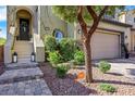 Inviting front entrance with stone steps, lush landscaping, and a charming door wreath at 10433 Mount Washington Ave, Las Vegas, NV 89166