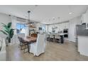 Open-concept kitchen with a large island, modern lighting, and stainless steel appliances at 10433 Mount Washington Ave, Las Vegas, NV 89166