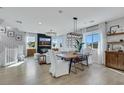 Bright and airy living room with wood floors, stylish decor, and ample natural light at 10433 Mount Washington Ave, Las Vegas, NV 89166