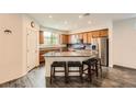 Kitchen featuring an island with granite countertops, wooden cabinets, and stainless steel appliances at 10663 Sariah Skye Ave, Las Vegas, NV 89166