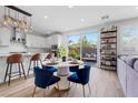 Bright dining area featuring a pendant light fixture, seating for four, and kitchen island at 11315 Gravitation Dr, Las Vegas, NV 89135