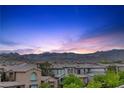 An elevated view of the neighborhood at sunset featuring mountain views at 11315 Gravitation Dr, Las Vegas, NV 89135
